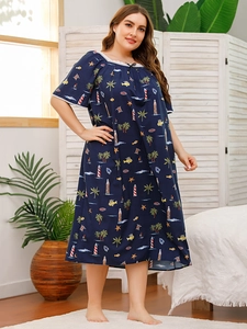 Detail of dark blue plus size nightgown featuring tropical ocean print and lace trim