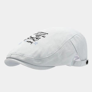 Detailed embroidery design on light blue cotton newsboy cap with cartoon cow motif