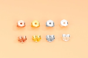Macro detail of S925 sterling silver butterfly earring backs in multiple color finishes