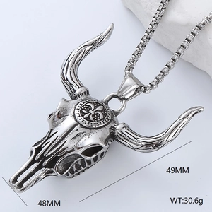 Macro shot of silver bull skull pendant on white rock, measuring 48mm by 49mm