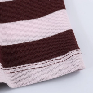 Close-up of wide striped knit sweater with detailed brown and pink stitching texture