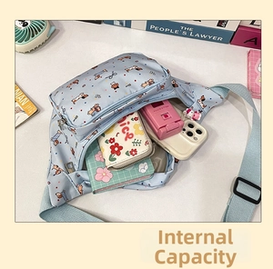 Internal view of light blue dog print chest bag showing storage for phone and wallet