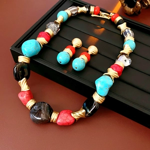 Detailed macro shot of vintage irregular geometric necklace and earrings with faux stones