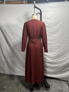Back view of long sleeve reddish brown maxi dress with waist pleats and hidden zipper
