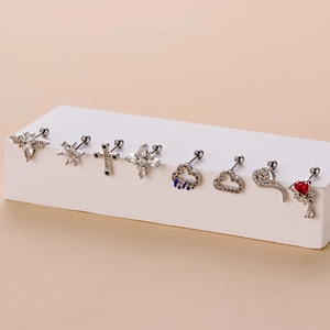 Detail shot of assorted stainless steel stud earrings with zirconia on a white pedestal