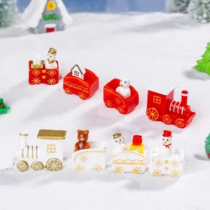 Miniature Christmas train set with snowman and bear figurines in a snowy winter scene