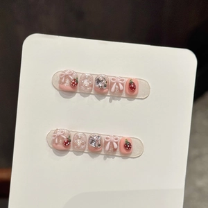 Handmade press-on nails for kids with 3D strawberry designs and pink bow decorations