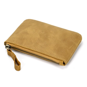 Detail of genuine brown crazy horse leather coin purse with zipper and metal ring