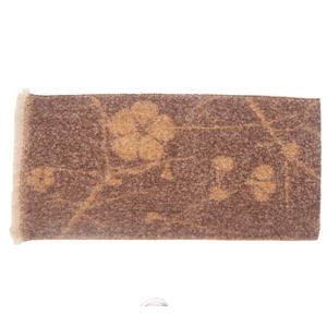 Close-up of brown and beige floral jacquard winter scarf with short fringe details