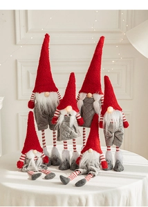 Detail of six Christmas gnomes with red hats and striped legs for festive home decor