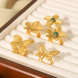 Gold vintage rings with butterfly and flower designs featuring turquoise green stones