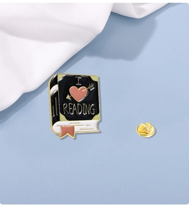 Detailed view of enamel book brooch featuring I Love Reading text and pink heart design