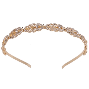 Golden bridal headband featuring sparkling crystal leaf patterns on a polished metal frame