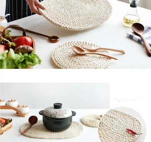 Detail of round handmade corn husk woven placemats in natural beige for heat insulation