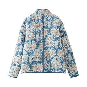 Detailed view of blue and white floral quilted jacket with thick cotton texture padding