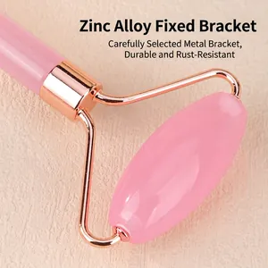 Pink face roller set with rose gold zinc alloy frame on a textured light background