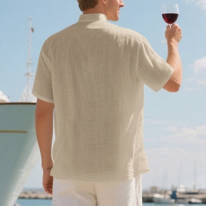 Men's casual beige linen short sleeve shirt shown in a luxury yacht marina setting