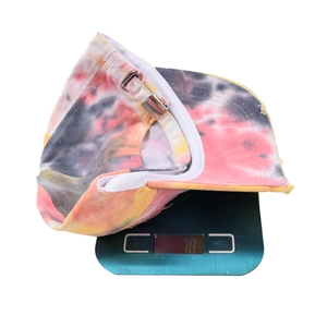 Outdoor tie-dye baseball cap in pink and yellow on scale weighing 78 grams