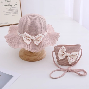 Pink straw sun hat and matching crossbody bag set with polka dot bows for girls