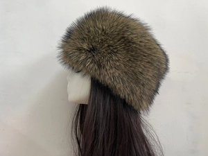 Detail view of the plush brown faux fur winter hat texture on a side mannequin display
