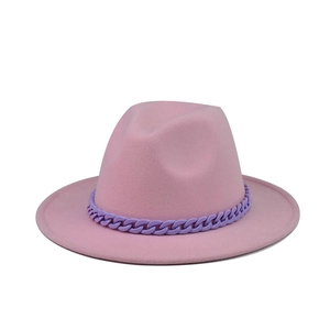 Detailed view of pink wool fedora hat featuring a stylish purple chain decoration