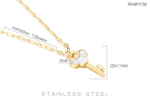 Macro shot of gold stainless steel key necklace featuring a delicate shell inlay pendant