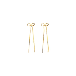 Boucles d'oreilles élégantes à nœud doré et pompons longs sur un fond blanc épuré