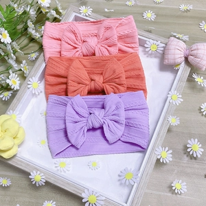 Three-pack soft nylon baby headbands with knitted texture and large decorative bows