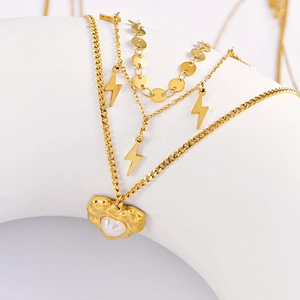 Layered gold necklace featuring lightning pendants and a heart charm with pearl inlay
