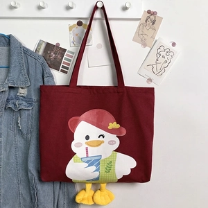 Detail of burgundy canvas tote bag with cute cartoon duck and 3D plush feet