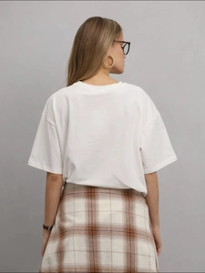 Vue arrière d'un T-shirt en coton blanc avec imprimé chien et jupe à carreaux
