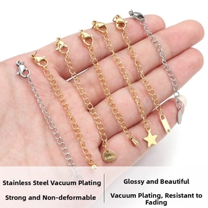 Detail of stainless steel extender chains with lobster clasps and star pendants in gold