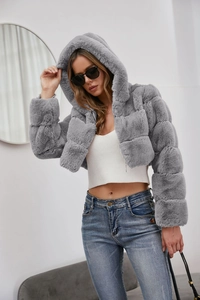 Close-up of a stylish grey faux fur hooded jacket with premium fluffy texture and soft lining