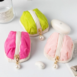 Quilted mini pouches in green and pink with pearl zipper charms for storage