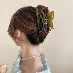 Minimalist acrylic butterfly hair claw clip in amber green for elegant updo hairstyles
