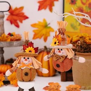 Detail of autumn gnome figurines with sunflowers and maple leaves for harvest decor