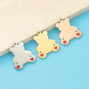 Three mirror-polished steel bear pendants in silver, gold, and rose gold with red hearts