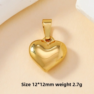 Polished gold heart pendant measuring 12x12mm weighing 2.7g on a stone base