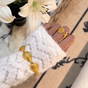 18k gold plated titanium steel bracelet and seashell ring set on woman's hand