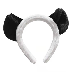 Detail view of plush panda ear headband showing soft black and white faux fur texture