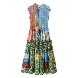 Macro detail of smocking texture and vibrant tropical print on a sleeveless maxi dress