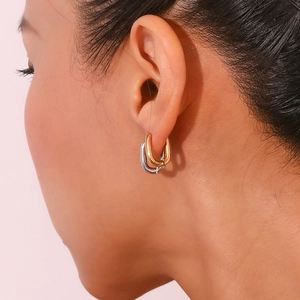 Classic U-shaped minimalist gold and silver stainless steel earrings worn by model