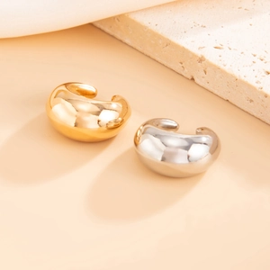 Detailed view of water drop metallic earrings in polished gold and silver finishes