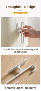 Macro view of white ABS power cord cable management hook with adhesive backing