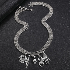 Silver punk layered necklace featuring spider web, skull, and skeleton hand pendants