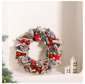 Close-up of Christmas wreath with natural pinecones and red wooden stars in home setting
