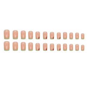 French tip press-on nails in light green with cute strawberry patterns on nude base