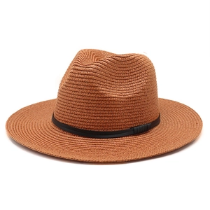 Detail of a brown straw Fedora hat featuring a flat brim and a minimalist black leather band