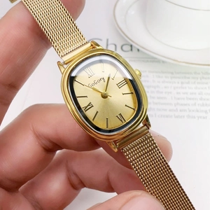Vintage gold oval quartz watch for women with Milanese mesh strap and Roman numerals