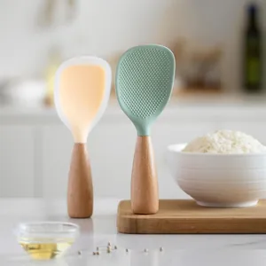 Standing silicone rice paddles with wooden handles in green and orange pastel colors